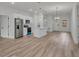 Modern living area featuring an island kitchen, stainless steel appliances, and wood-look floors at 357 Marion Oaks Pass, Ocala, FL 34473