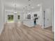 Open concept living area with modern light fixtures, a kitchen island, and lots of light at 357 Marion Oaks Pass, Ocala, FL 34473