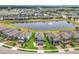 Expansive aerial view of a suburban neighborhood featuring a central pond with fountain feature at 3961 Crawley Down Loop, Sanford, FL 32773