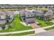 Aerial view of a two-story home with a well-manicured lawn near a peaceful pond at 3961 Crawley Down Loop, Sanford, FL 32773