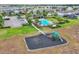 Aerial view of a community park with a pool, playground, parking, and lawn, providing space for recreation at 3961 Crawley Down Loop, Sanford, FL 32773