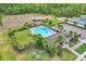 Aerial view showcases a community pool, playground, and parking, surrounded by lush landscaping and trees at 3961 Crawley Down Loop, Sanford, FL 32773