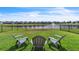 A pleasant backyard, with a well-maintained lawn and a peaceful view of the neighborhood pond and fountain at 3961 Crawley Down Loop, Sanford, FL 32773