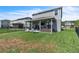 Fenced backyard with a covered patio and green lawn, perfect for outdoor enjoyment at 3961 Crawley Down Loop, Sanford, FL 32773