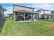 Lush fenced backyard with a covered patio, barbecue, and outdoor seating area at 3961 Crawley Down Loop, Sanford, FL 32773