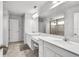 Elegant bathroom with dual vanities, a large mirror, and a glass-enclosed shower at 3961 Crawley Down Loop, Sanford, FL 32773