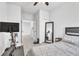 Bedroom featuring modern exercise equipment, ample natural light, and a cozy bed setup with full length mirror at 3961 Crawley Down Loop, Sanford, FL 32773