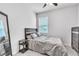Comfortable bedroom with modern decor featuring a full bed, a sleek dresser, and a floor-length mirror at 3961 Crawley Down Loop, Sanford, FL 32773