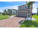 Attractive home featuring a brick driveway, and front lawn, enhancing the property's curb appeal at 3961 Crawley Down Loop, Sanford, FL 32773