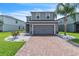 Charming two-story home featuring a brick driveway and a well-maintained front yard with meticulous landscaping at 3961 Crawley Down Loop, Sanford, FL 32773