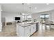 Bright, open kitchen features a granite island with a stainless steel dishwasher and overlooks the living area at 3961 Crawley Down Loop, Sanford, FL 32773