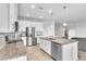 Modern kitchen featuring stainless steel appliances, granite countertops, and white cabinetry at 3961 Crawley Down Loop, Sanford, FL 32773
