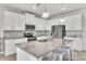 Modern kitchen featuring white cabinetry, granite countertops, stainless steel appliances, and a spacious island at 3961 Crawley Down Loop, Sanford, FL 32773