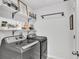 Bright laundry room featuring a GE washer and dryer, shelving and modern decor at 3961 Crawley Down Loop, Sanford, FL 32773