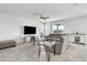 Comfortable living room with a plush sectional sofa, tile floors, and a stylish entertainment center at 3961 Crawley Down Loop, Sanford, FL 32773