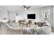 Inviting living room with plush gray sectional, a modern fireplace, and neutral tones for a cozy atmosphere at 3961 Crawley Down Loop, Sanford, FL 32773