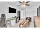 Spacious living room boasts modern decor, a flat-screen TV, and a cozy seating area with a uniquely designed coffee table at 3961 Crawley Down Loop, Sanford, FL 32773