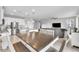 Open-concept living space with a kitchen island, dining table, and seating area, perfect for entertaining at 3961 Crawley Down Loop, Sanford, FL 32773