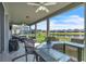 Spacious covered patio overlooking a fenced backyard with a serene water view at 3961 Crawley Down Loop, Sanford, FL 32773