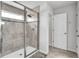 Modern walk-in shower featuring neutral tiling, glass door, and a built-in bench at 3961 Crawley Down Loop, Sanford, FL 32773