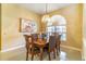 Elegant dining room with a classic chandelier and ample natural light at 4218 Inwood Landing Dr, Orlando, FL 32812