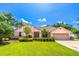 Charming single-story home with manicured lawn, well-kept landscaping, and a welcoming two-car garage at 4218 Inwood Landing Dr, Orlando, FL 32812