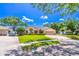 Welcoming single-story home featuring a well-manicured lawn, mature trees, and a convenient two-car garage at 4218 Inwood Landing Dr, Orlando, FL 32812