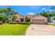 Charming single-story home with a well-manicured lawn and lush landscaping at 4218 Inwood Landing Dr, Orlando, FL 32812