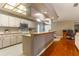 Well-lit kitchen with bar and view to office space, ideal for modern living and multitasking at 4218 Inwood Landing Dr, Orlando, FL 32812