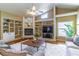 Bright living room featuring built-in shelves, a fireplace, and hardwood floors at 4218 Inwood Landing Dr, Orlando, FL 32812