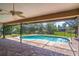 A pool with a screen enclosure and brick flooring in a backyard at 4218 Inwood Landing Dr, Orlando, FL 32812