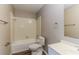 Bathroom with a white vanity, toilet, mirror, and tub with white tiling at 4265 Old Colony Rd, Mulberry, FL 33860