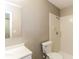 Bathroom with a white vanity, toilet, mirror, and shower with white tiling at 4265 Old Colony Rd, Mulberry, FL 33860