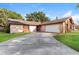 View of the driveway leading to a single Gathering home with a spacious garage at 4265 Old Colony Rd, Mulberry, FL 33860
