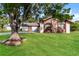 Charming single-Gathering home with wood and stone facade and lush green lawn and mature trees at 4265 Old Colony Rd, Mulberry, FL 33860