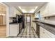 Galley kitchen featuring stainless appliances, dark countertops and light colored cabinets at 4265 Old Colony Rd, Mulberry, FL 33860