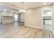 View of living room showcasing fireplace, wood floor and access to the kitchen at 4265 Old Colony Rd, Mulberry, FL 33860