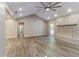 Bright living room with wood flooring, stone fireplace, and access to other rooms at 4265 Old Colony Rd, Mulberry, FL 33860