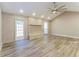 Bright living room featuring vaulted ceilings, stone fireplace, ceiling fan and wood-look floors at 4265 Old Colony Rd, Mulberry, FL 33860
