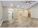 Spacious open floor plan showcasing wood floors and seamless transitions to the kitchen and dining areas at 4265 Old Colony Rd, Mulberry, FL 33860
