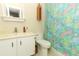 Bright bathroom featuring a vanity with framed mirror and vibrant floral shower curtain at 474 Windmeadows St # 0, Altamonte Springs, FL 32701