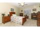 Comfortable bedroom showcasing a floral-patterned bed, natural light, and wooden furniture at 474 Windmeadows St # 0, Altamonte Springs, FL 32701