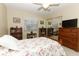 Comfortable bedroom showcasing a floral-patterned bed, natural light, and mirrored closet at 474 Windmeadows St # 0, Altamonte Springs, FL 32701