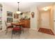 Charming dining area featuring a round table with red cushioned chairs and a view of the kitchen at 474 Windmeadows St # 0, Altamonte Springs, FL 32701