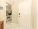 Bright entryway featuring white tile floors, a white door, and a glimpse into the adjacent kitchen space at 474 Windmeadows St # 0, Altamonte Springs, FL 32701