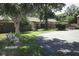Quaint villa exterior featuring mature landscaping, a bench, and an inviting curb appeal at 474 Windmeadows St # 0, Altamonte Springs, FL 32701