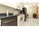 Bright kitchen featuring white cabinets, appliances, and tile floors with an adjacent door and a black refrigerator at 474 Windmeadows St # 0, Altamonte Springs, FL 32701