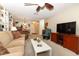 Bright living room features a cozy seating area, built-in bookshelves, and a ceiling fan at 474 Windmeadows St # 0, Altamonte Springs, FL 32701