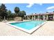 A community swimming pool with lounge chairs and shade umbrellas on a sunny day with blue skies at 474 Windmeadows St # 0, Altamonte Springs, FL 32701