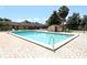 Enjoy the community pool with blue water, brick surround, and lounge chairs under the beautiful blue sky at 474 Windmeadows St # 0, Altamonte Springs, FL 32701
